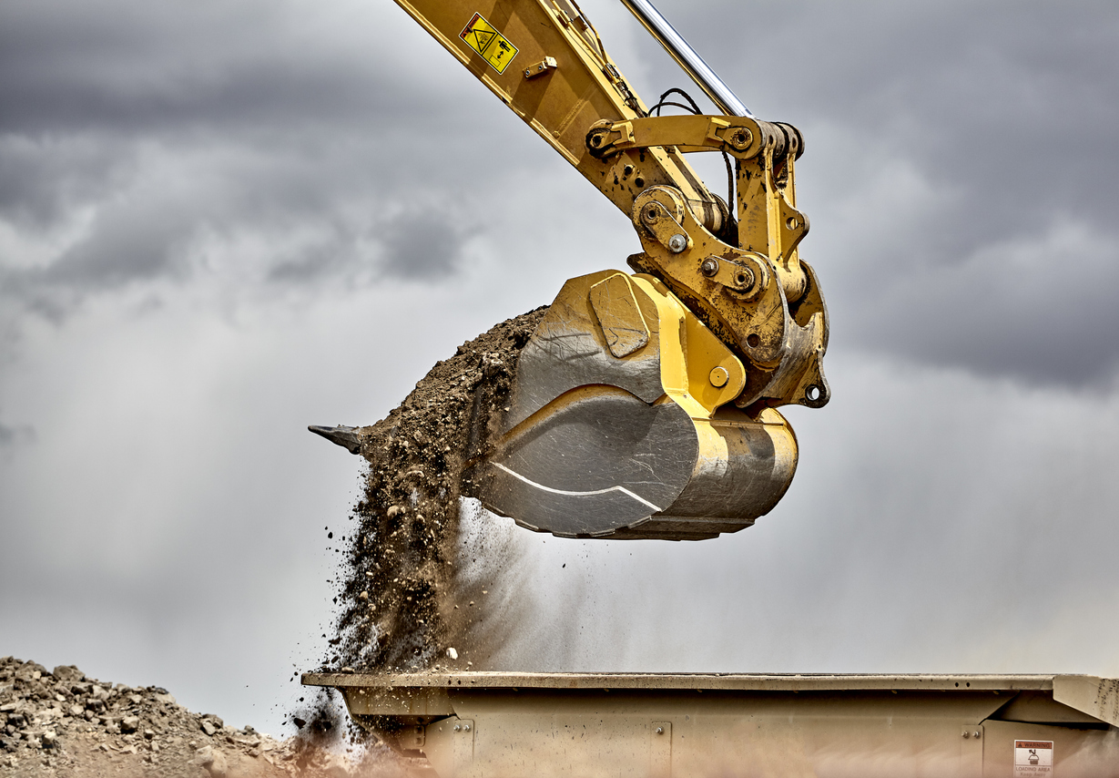 construction-industry-excavator-bucket-loading-gravel-closeup